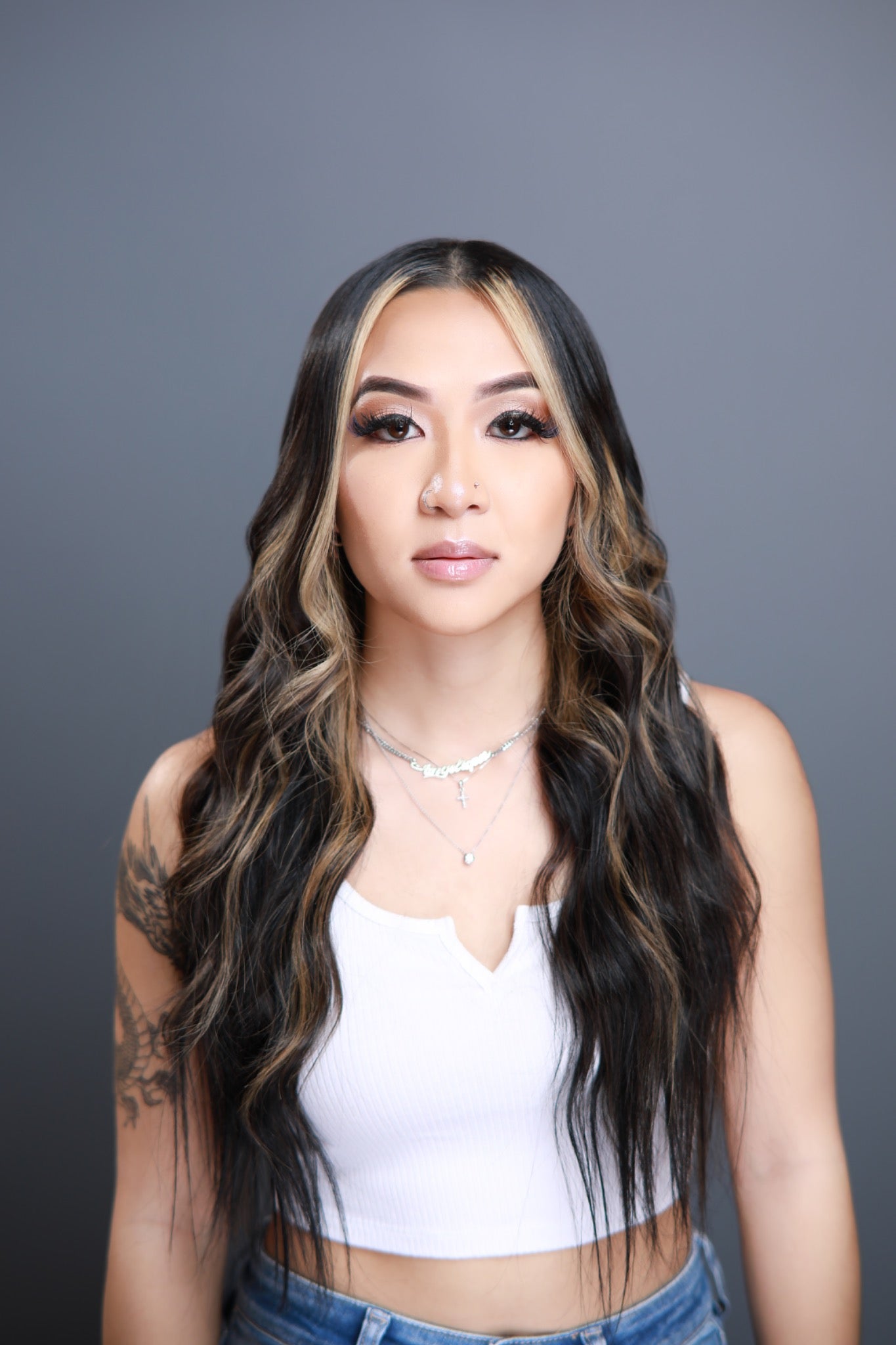 B. Xquisit straight raw hair bundles styled in soft waves