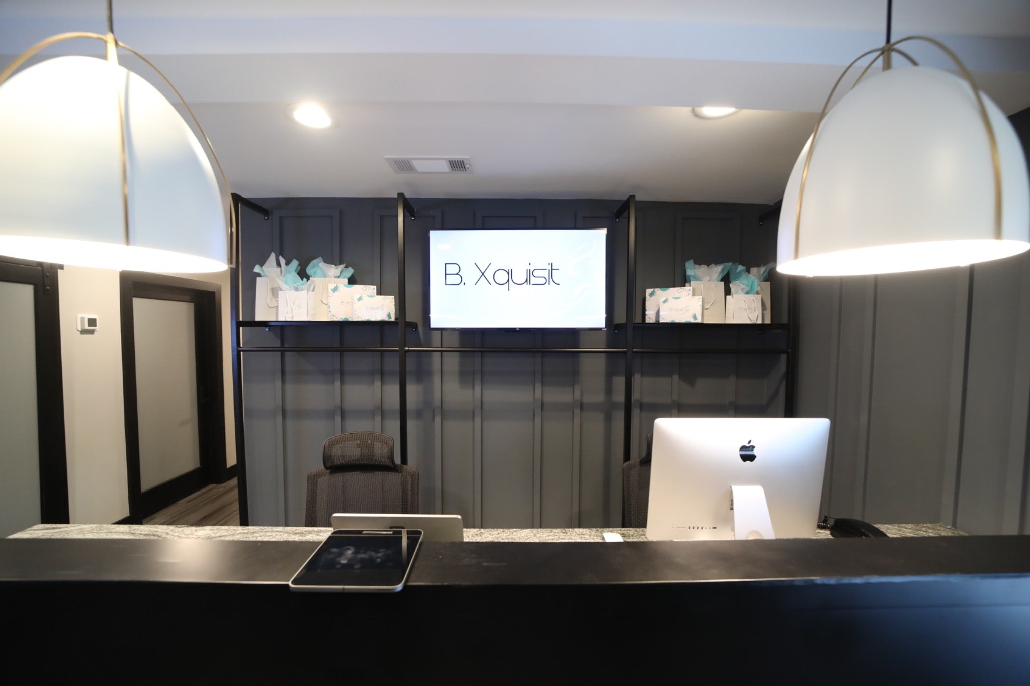 B. Xquisit Studios front reception desk